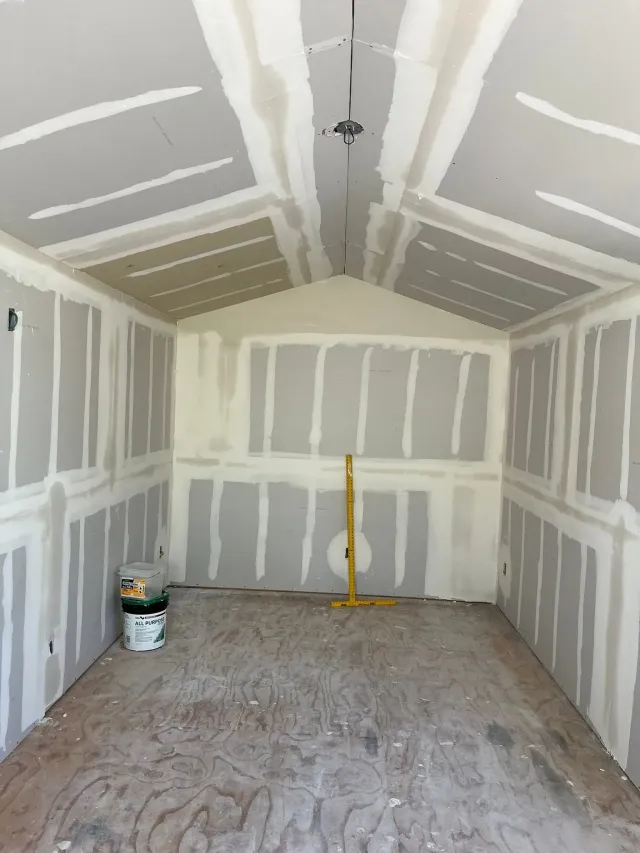 Newly installed drywall with taped and mudded seams in a vaulted-ceiling room in Tempe, AZ
